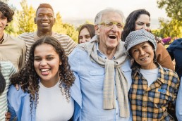 Group of multigenerational people smiling and having fun in front of camera.