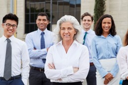 Group or eight people dressed in business clothes outside