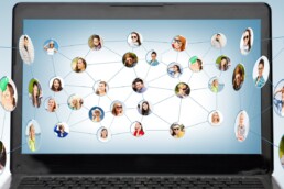 a web diagram showing inter-related images of a peoples faces in front of a laptop screen